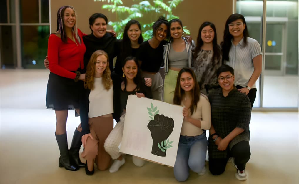 Students with environmental justice sign