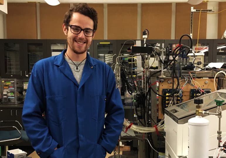 Researcher in blue lab coat